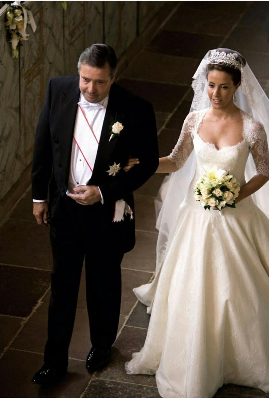 العروس في الممر على ذراع والدها آلان كافاليير- الصورة من حساب Royal Denmark على إنستغرام
